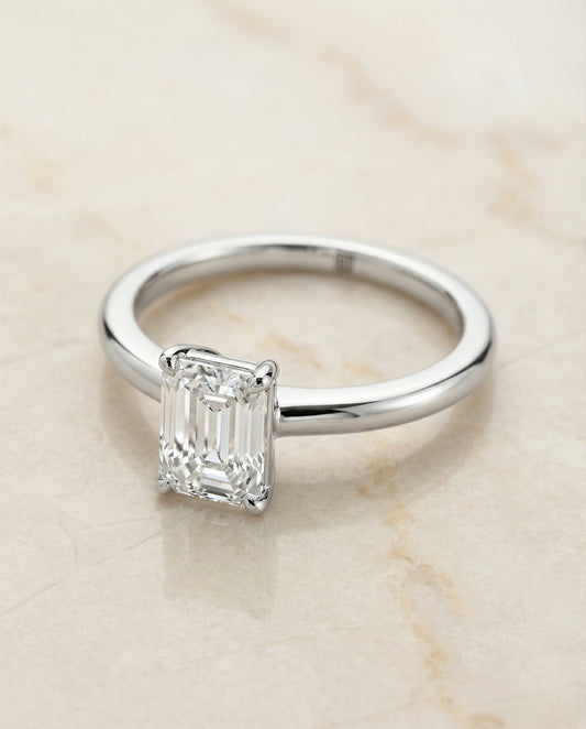 European Cut, Round Comfort Fit Claw Prong Solitaire Emerald, in 18K White Gold – angled view | RockHer