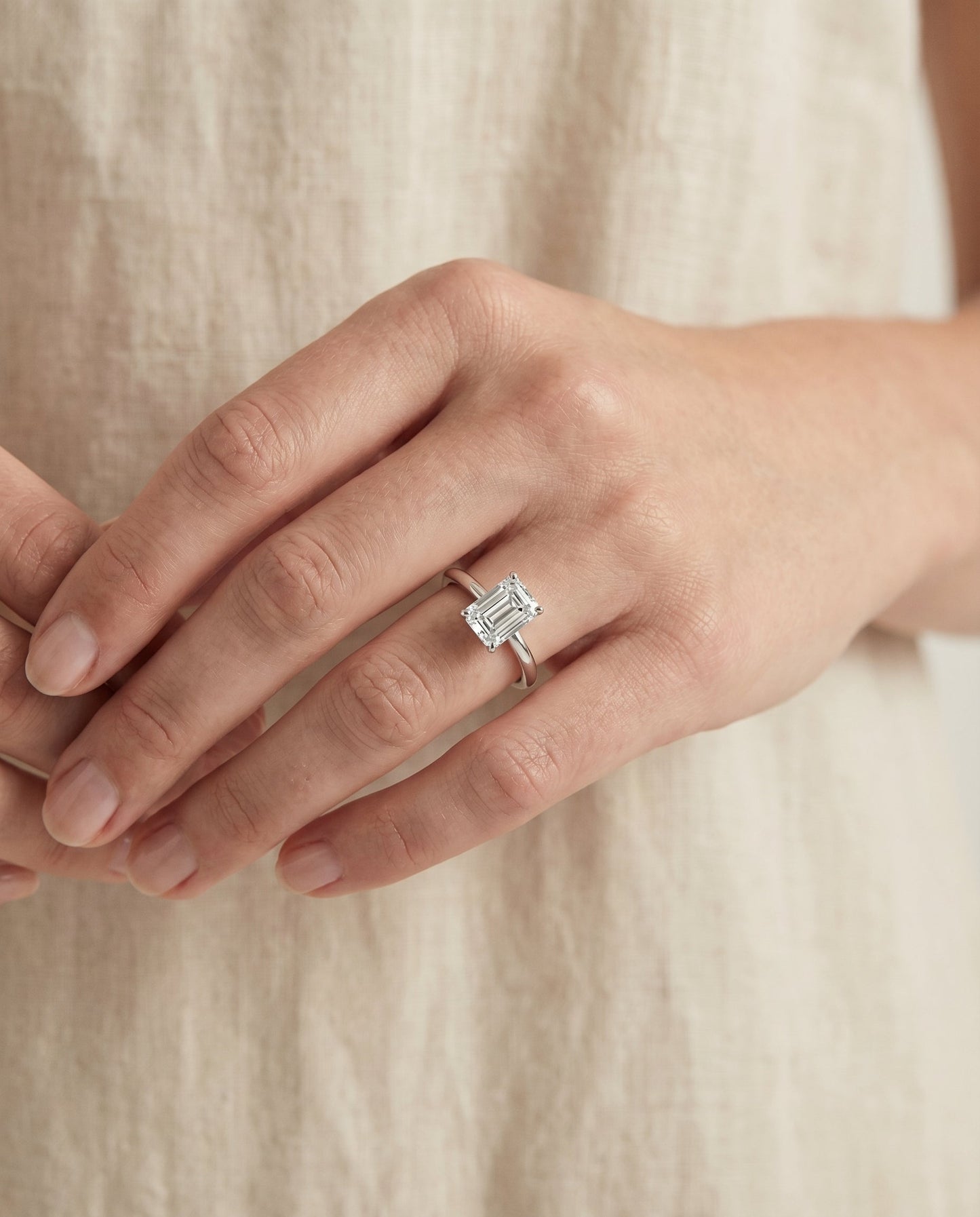 European Cut, Round Comfort Fit Claw Prong Solitaire Emerald, in 18K White Gold – lifestyle shot | RockHer
