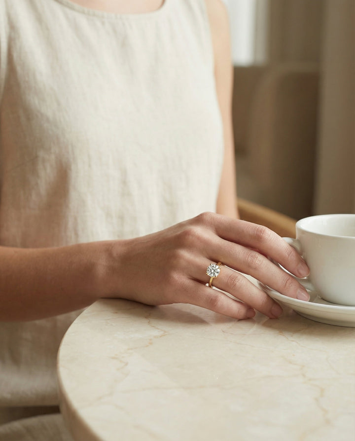 Secret Halo Adorned Prong Solitaire Cushion, in 18K Yellow Gold – lifestyle shot | RockHer