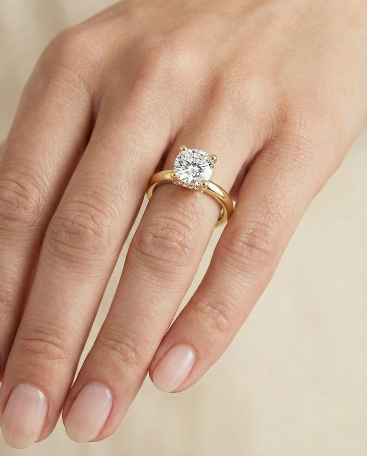 Secret Halo Adorned Prong Solitaire Cushion, in 18K Yellow Gold – lifestyle shot | RockHer