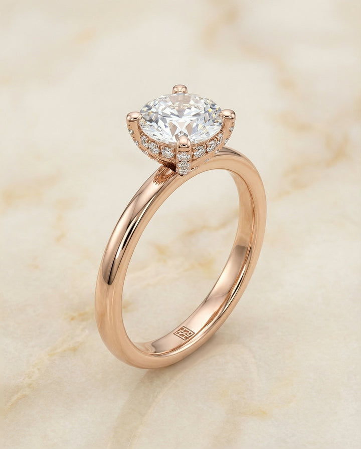 Round Brilliant, Secret Halo Adorned Prong Solitaire, in 14K Rose Gold – angled view | RockHer