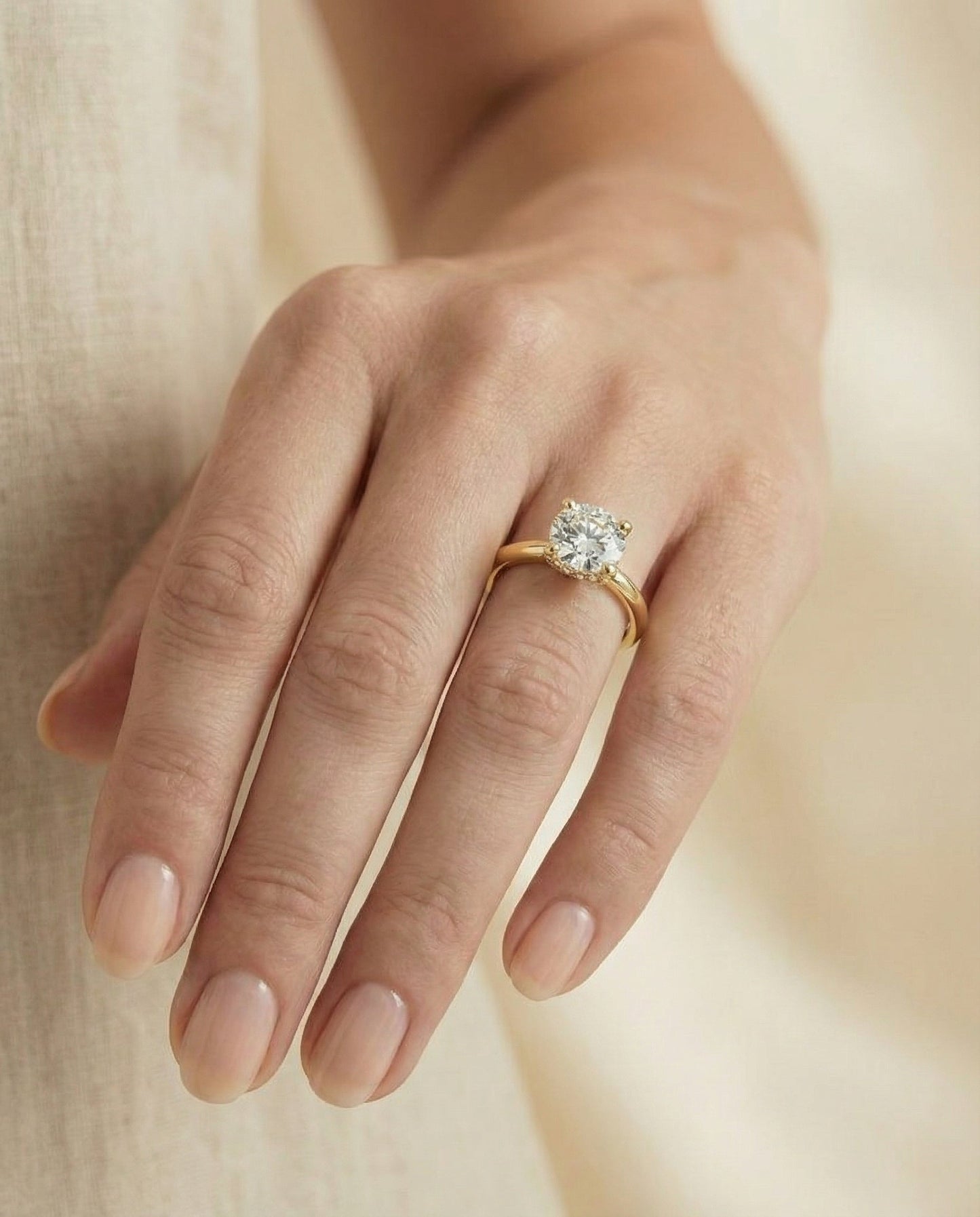 Round Brilliant, Secret Halo Adorned Prong Solitaire, in 18K Yellow Gold – lifestyle shot | RockHer