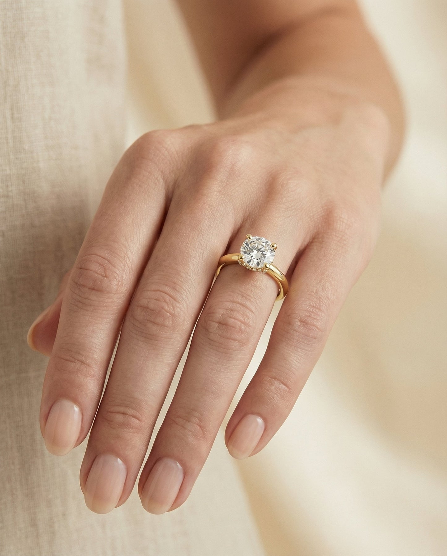 Round Brilliant, Secret Halo Adorned Prong Solitaire, in 18K Yellow Gold – lifestyle shot | RockHer