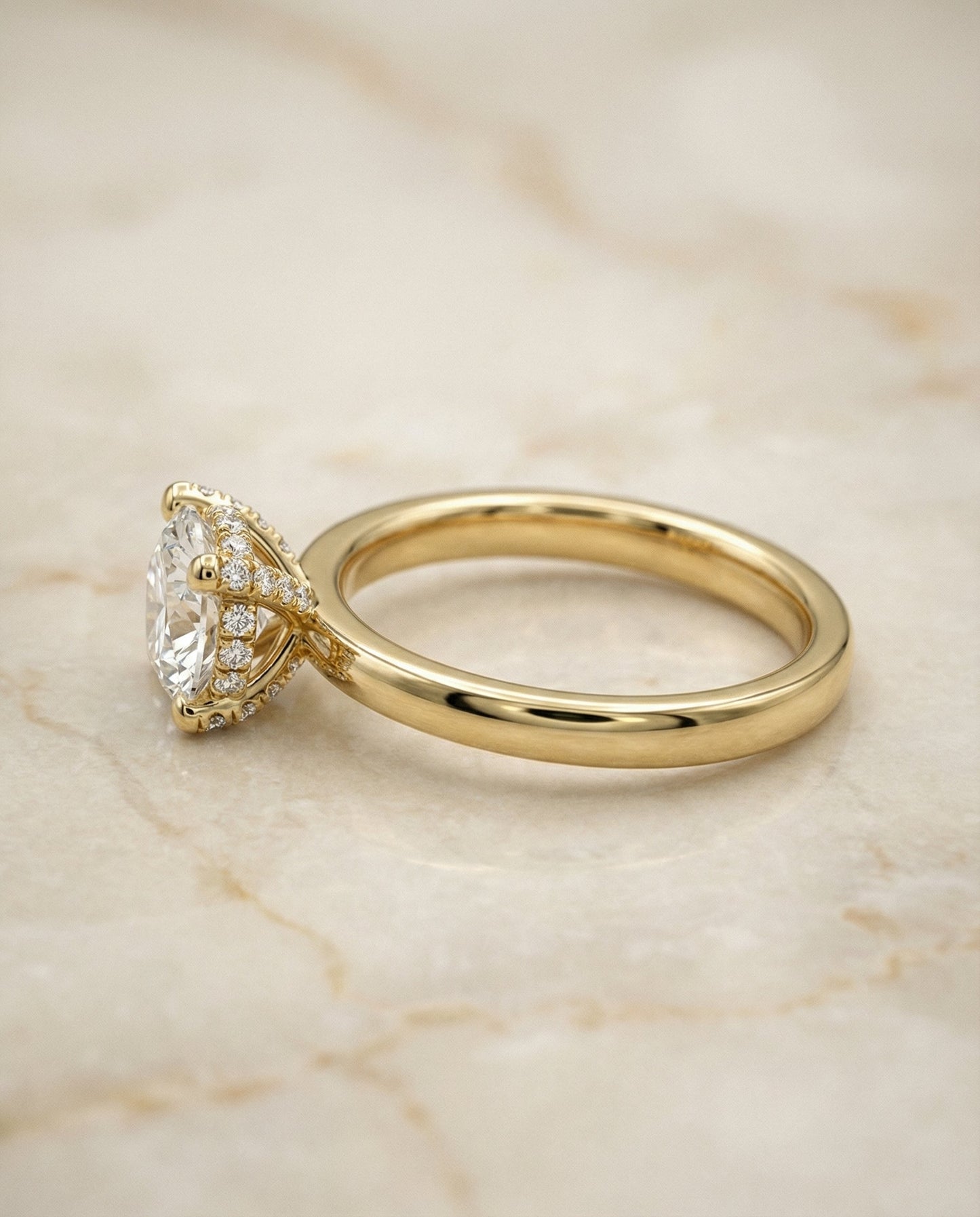 Round Brilliant, Secret Halo Adorned Prong Solitaire, in 18K Yellow Gold – side profile | RockHer