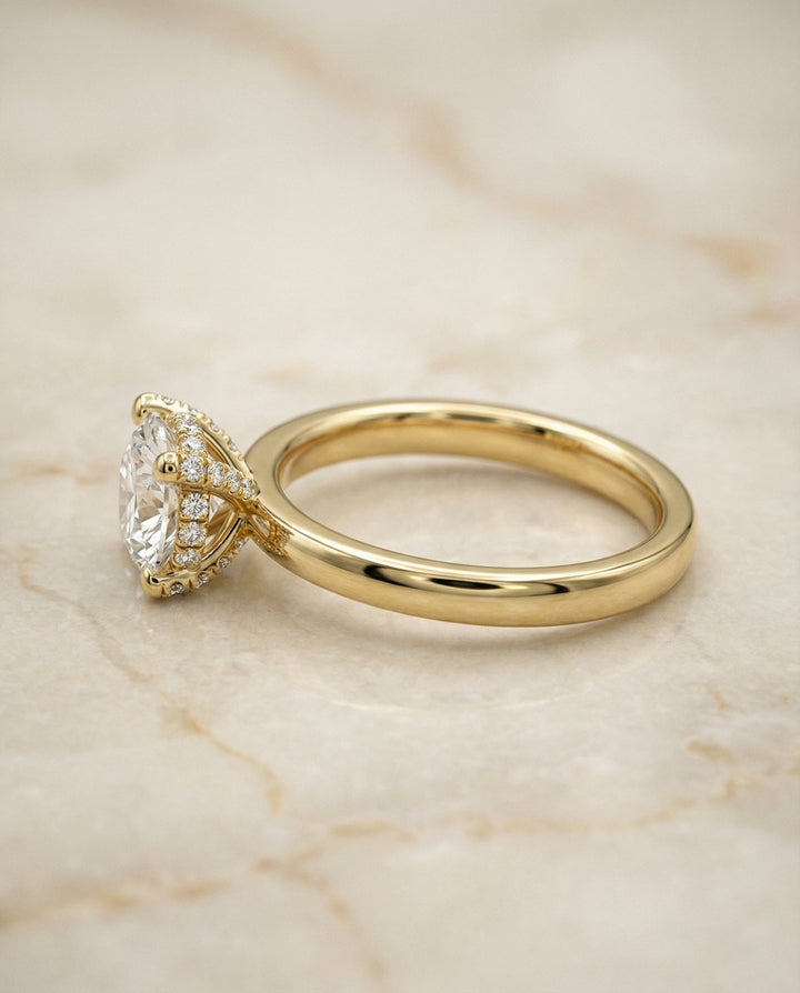 Round Brilliant, Secret Halo Adorned Prong Solitaire, in 18K Yellow Gold – side profile | RockHer