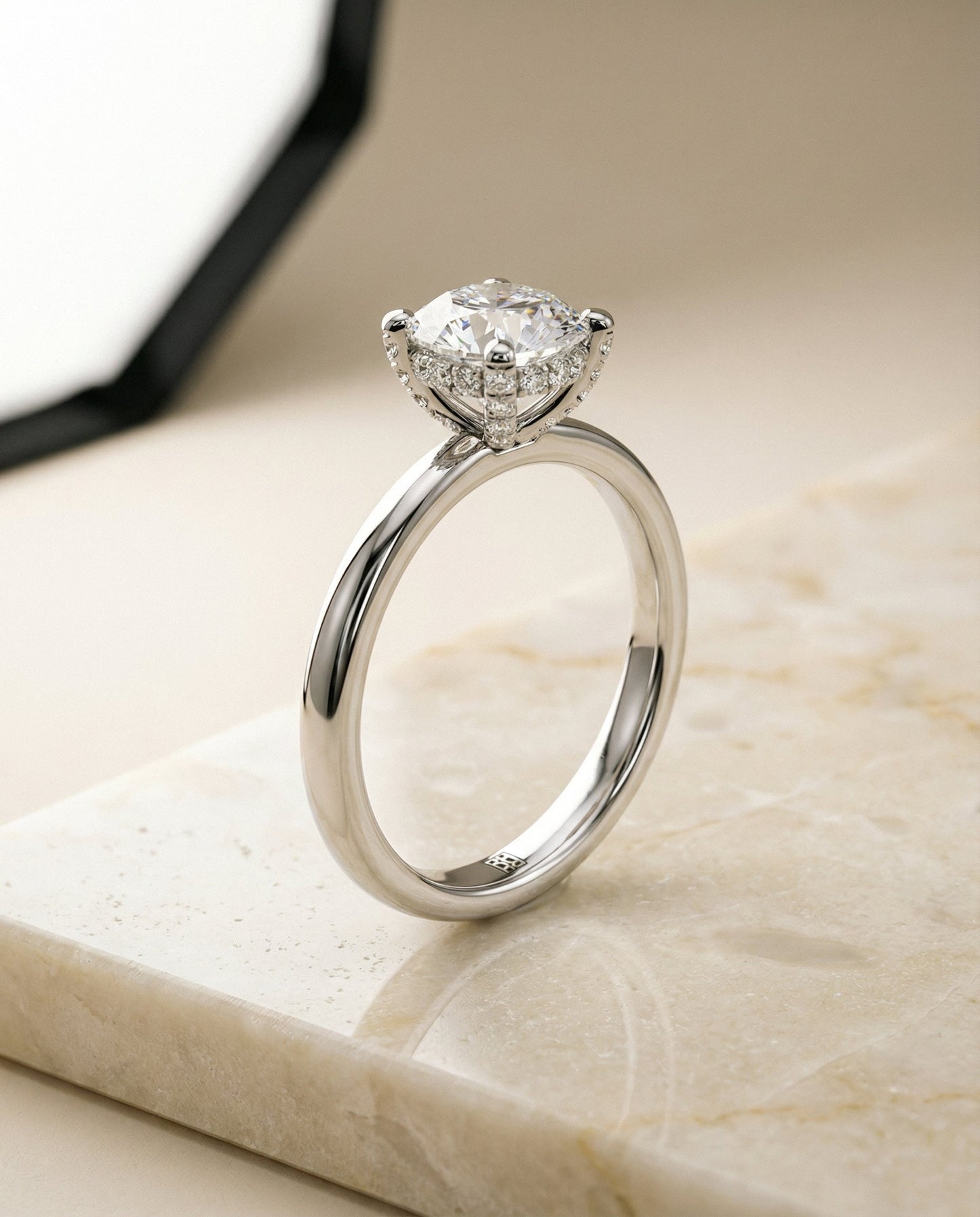 Round Brilliant, Secret Halo Adorned Prong Solitaire, in Platinum – front view | RockHer