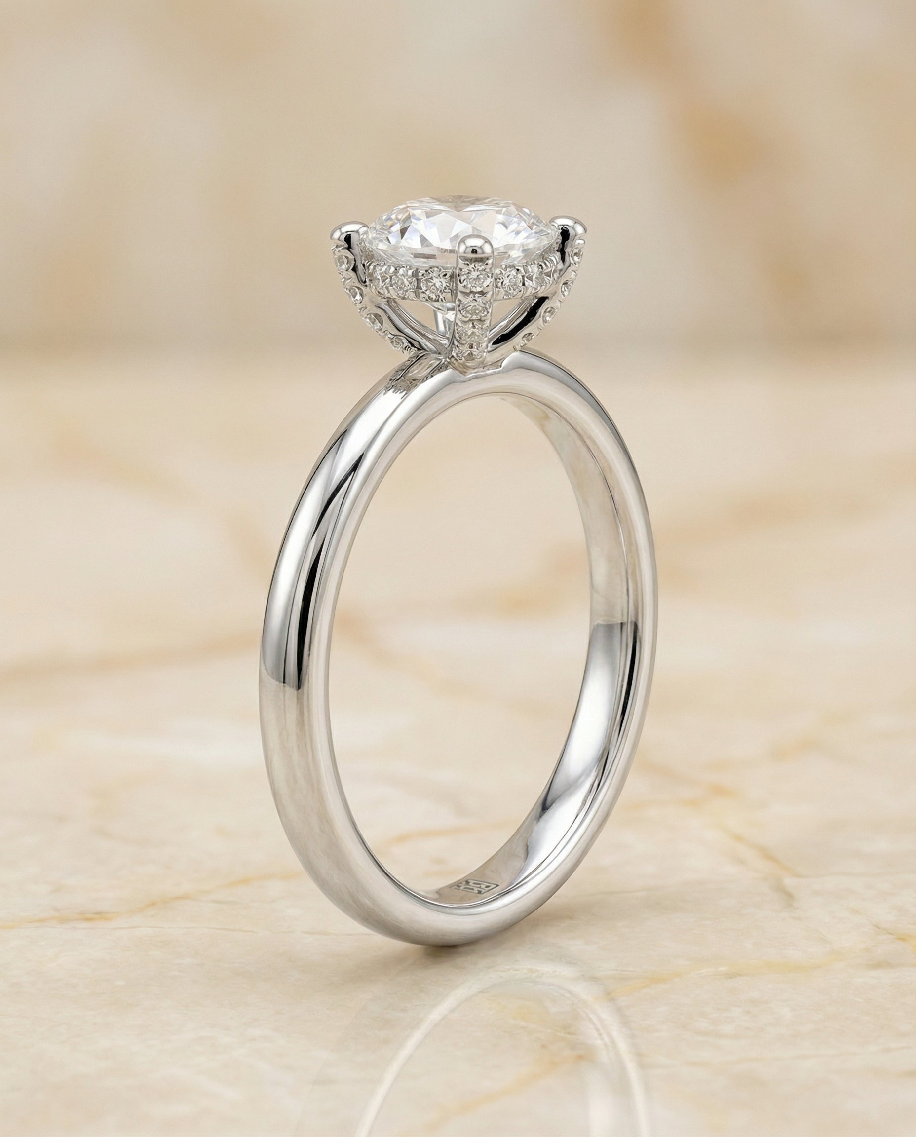 Round Brilliant, Secret Halo Adorned Prong Solitaire, in Platinum – side profile | RockHer