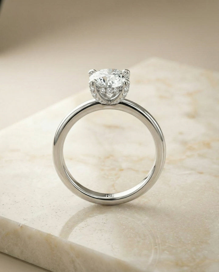 Round Brilliant, Secret Halo Adorned Prong Solitaire, in Platinum – side profile | RockHer