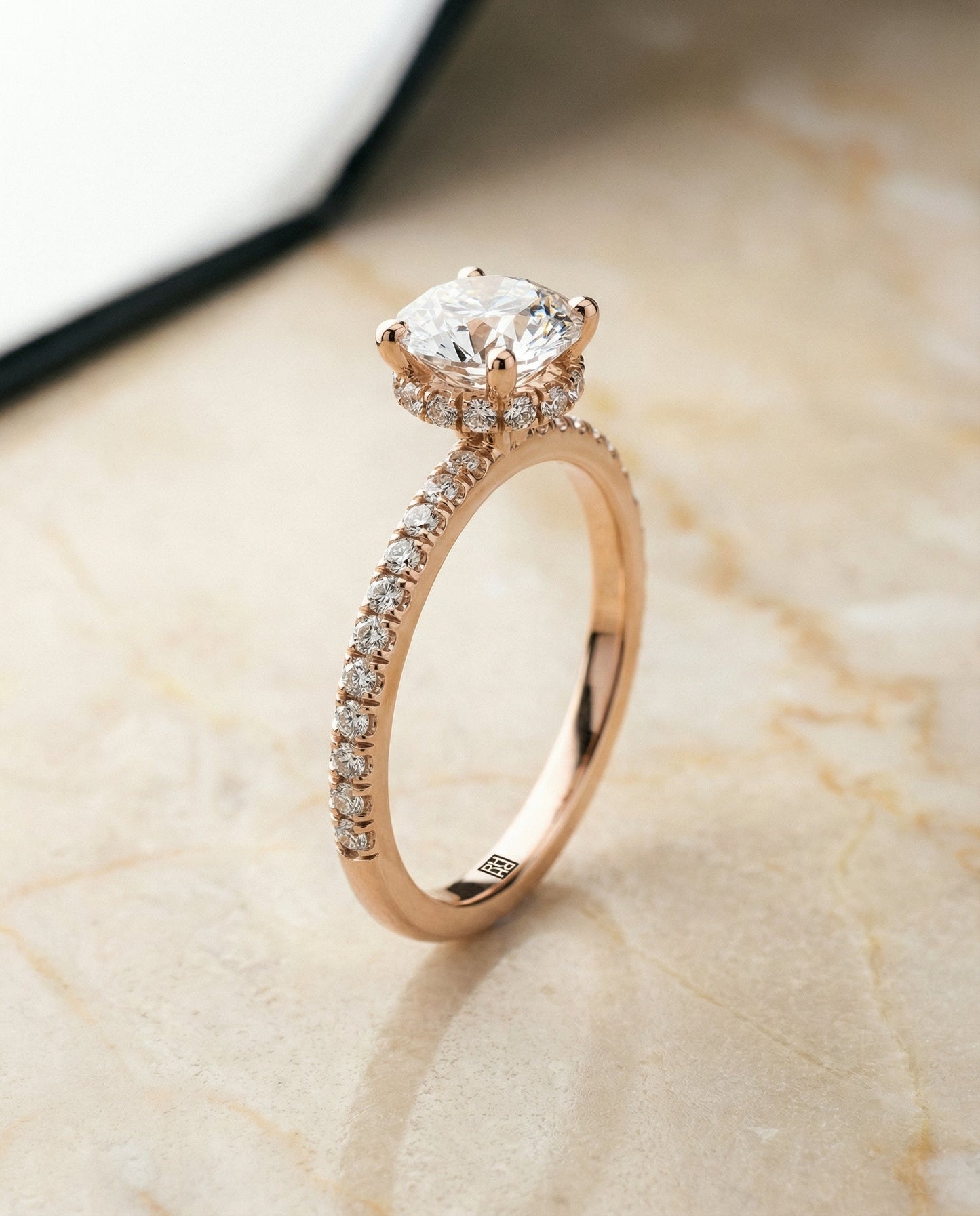 Round Brilliant, Secret Halo French Pavé Solitaire, in 14K Rose Gold, prong setting – front view | RockHer