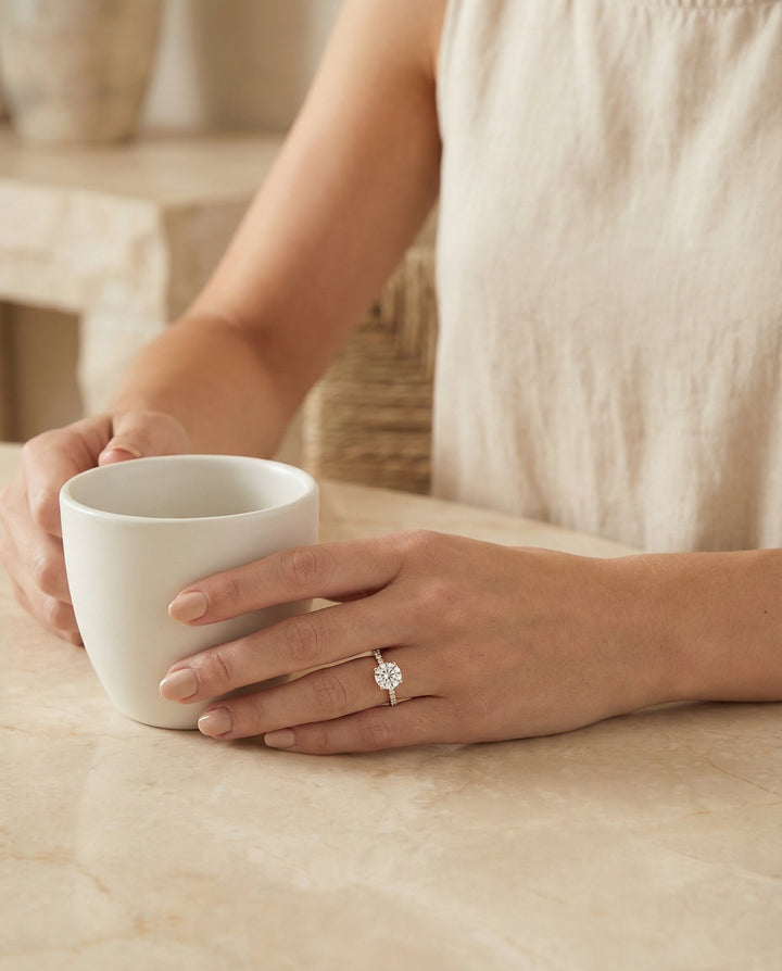 Round Brilliant, Secret Halo French Pavé Solitaire, in 14K Rose Gold, prong setting – lifestyle shot | RockHer