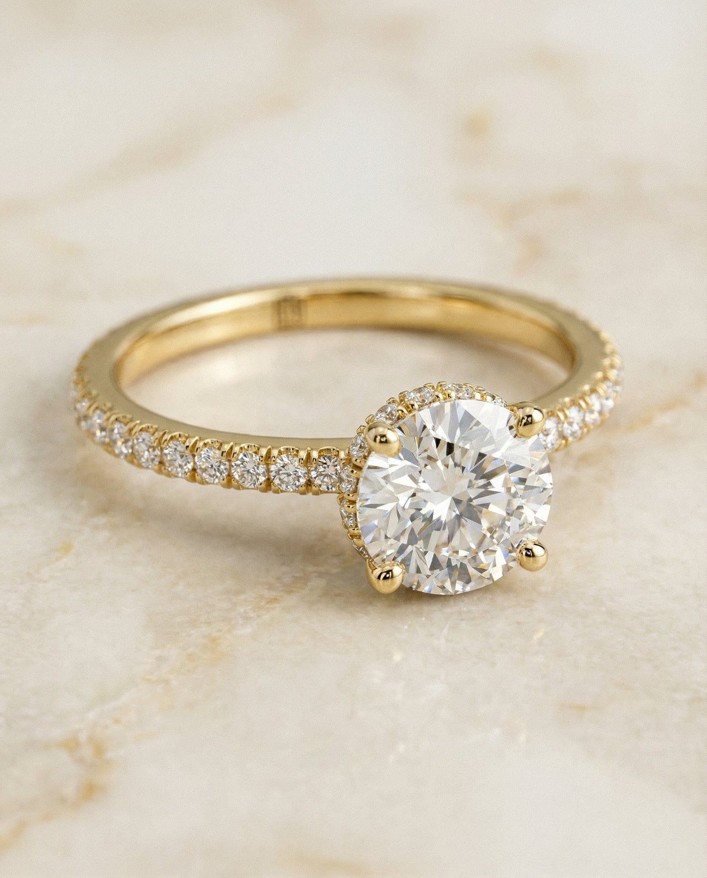 Round Brilliant, Secret Halo French Pavé Solitaire, in 18K Yellow Gold – angled view | RockHer