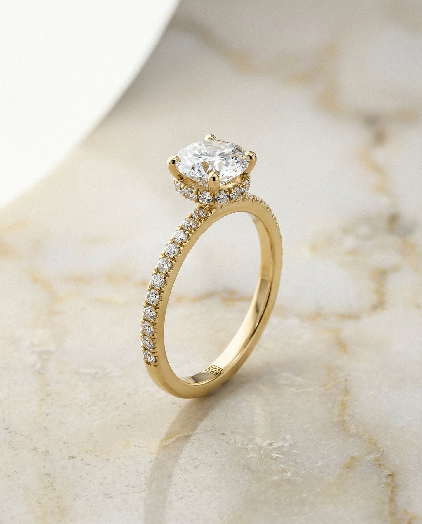 Round Brilliant, Secret Halo French Pavé Solitaire, in 18K Yellow Gold – front view | RockHer