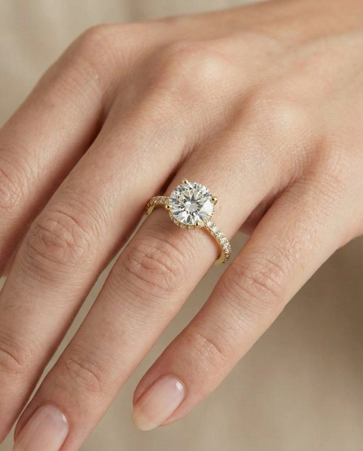 Round Brilliant, Secret Halo French Pavé Solitaire, in 18K Yellow Gold – lifestyle shot | RockHer