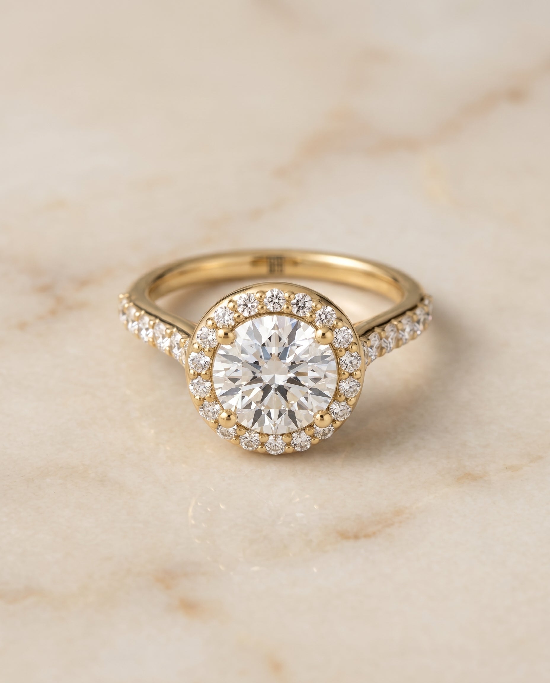 Round Brilliant, Shared Prong Halo Round, in 18K Yellow Gold, pave setting – angled view | RockHer