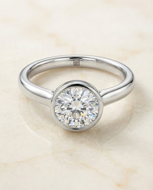 Round Brilliant, Simple Bezel Solitaire, in Platinum – angled view | RockHer