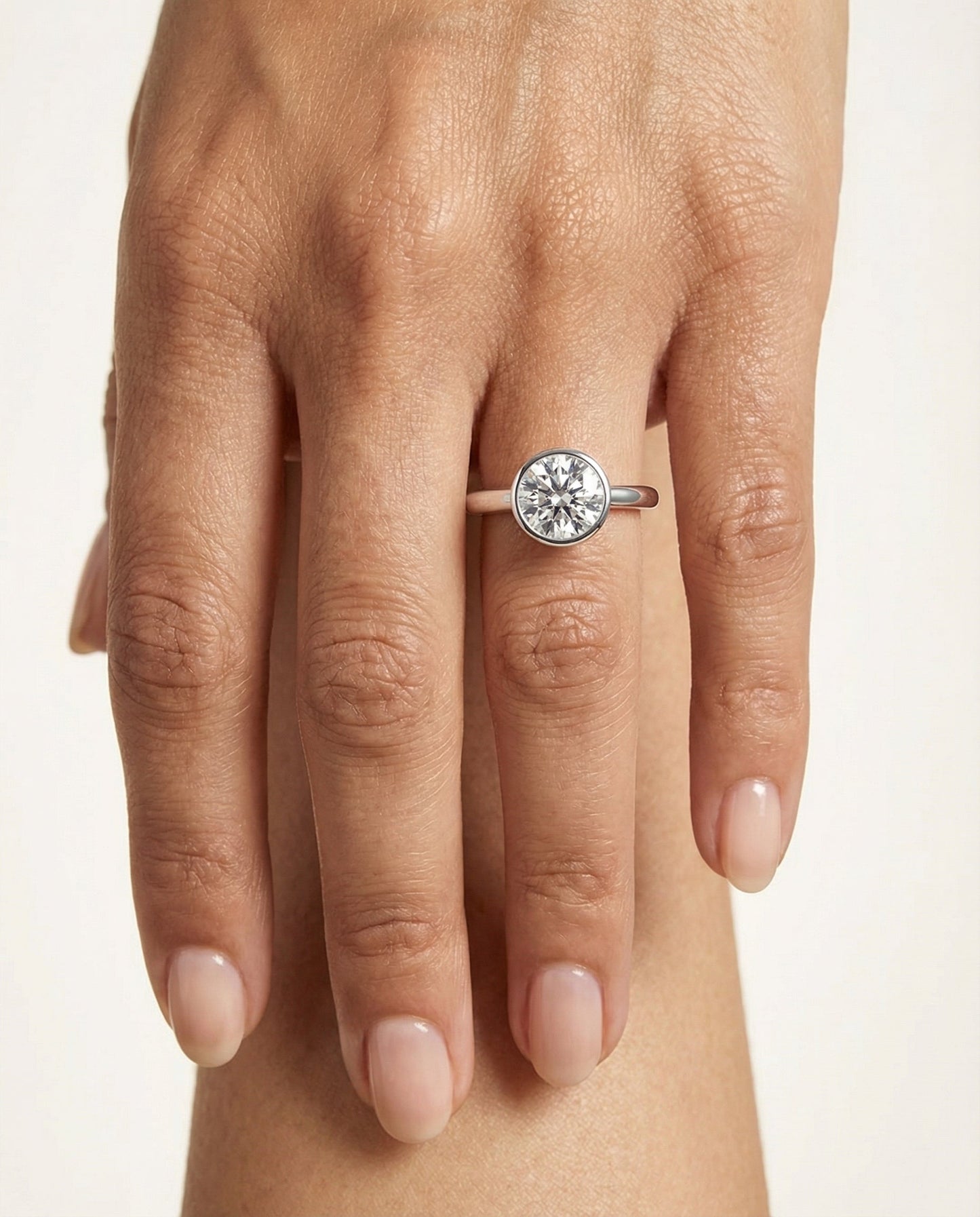 Round Brilliant, Simple Bezel Solitaire, in Platinum – lifestyle shot | RockHer