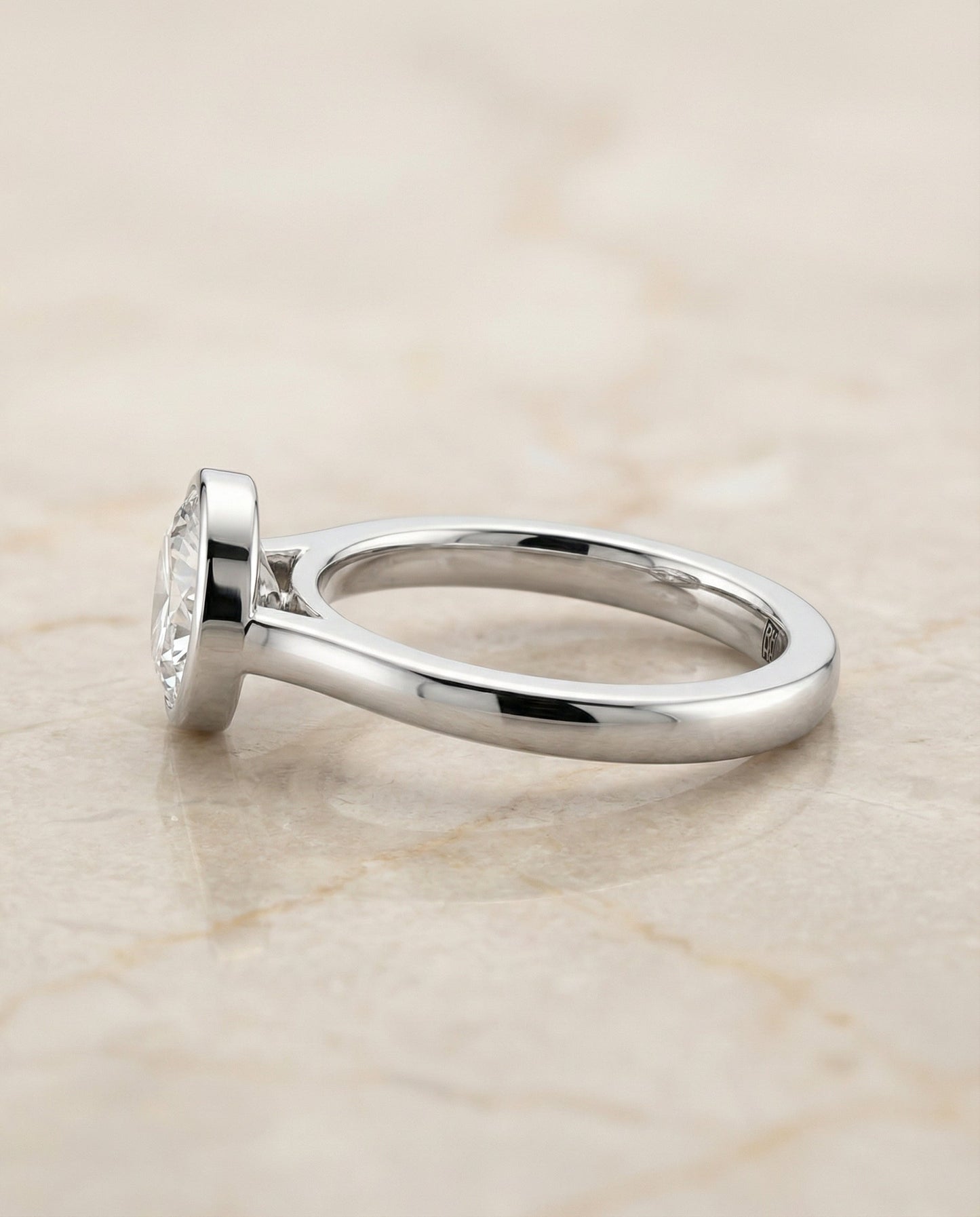Round Brilliant, Simple Bezel Solitaire, in Platinum – side profile | RockHer