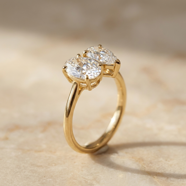 Solange Toi et Moi Oval & Pear Engagement Ring Setting - Alt angle on warm marble