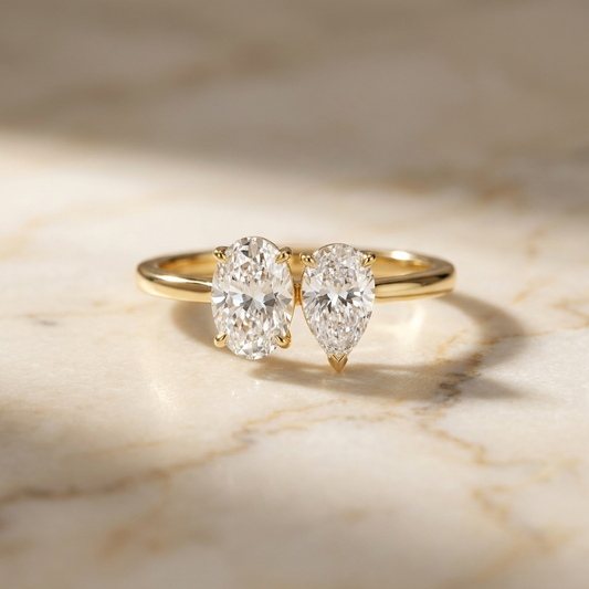 Solange Toi et Moi Oval & Pear Engagement Ring Setting - Hero on warm marble