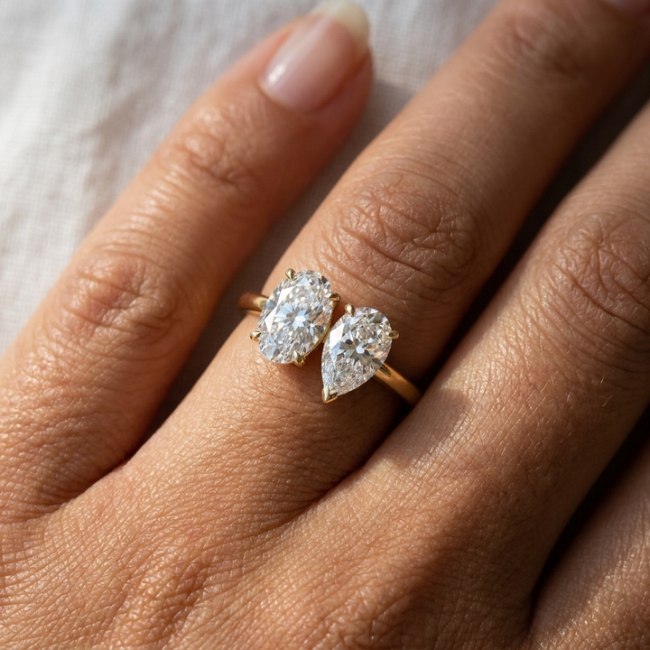 18K Yellow Gold Solange Toi et Moi Select Oval & Pear Lab Diamond Engagement Ring - Macro close-up on finger