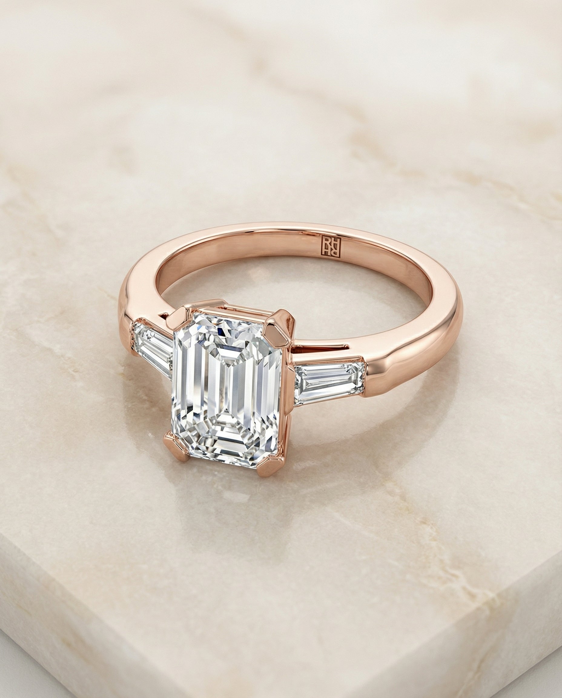 European Cut, Tapered Baguette Three Stone Emerald, in 14K Rose Gold, prong setting – angled view | RockHer