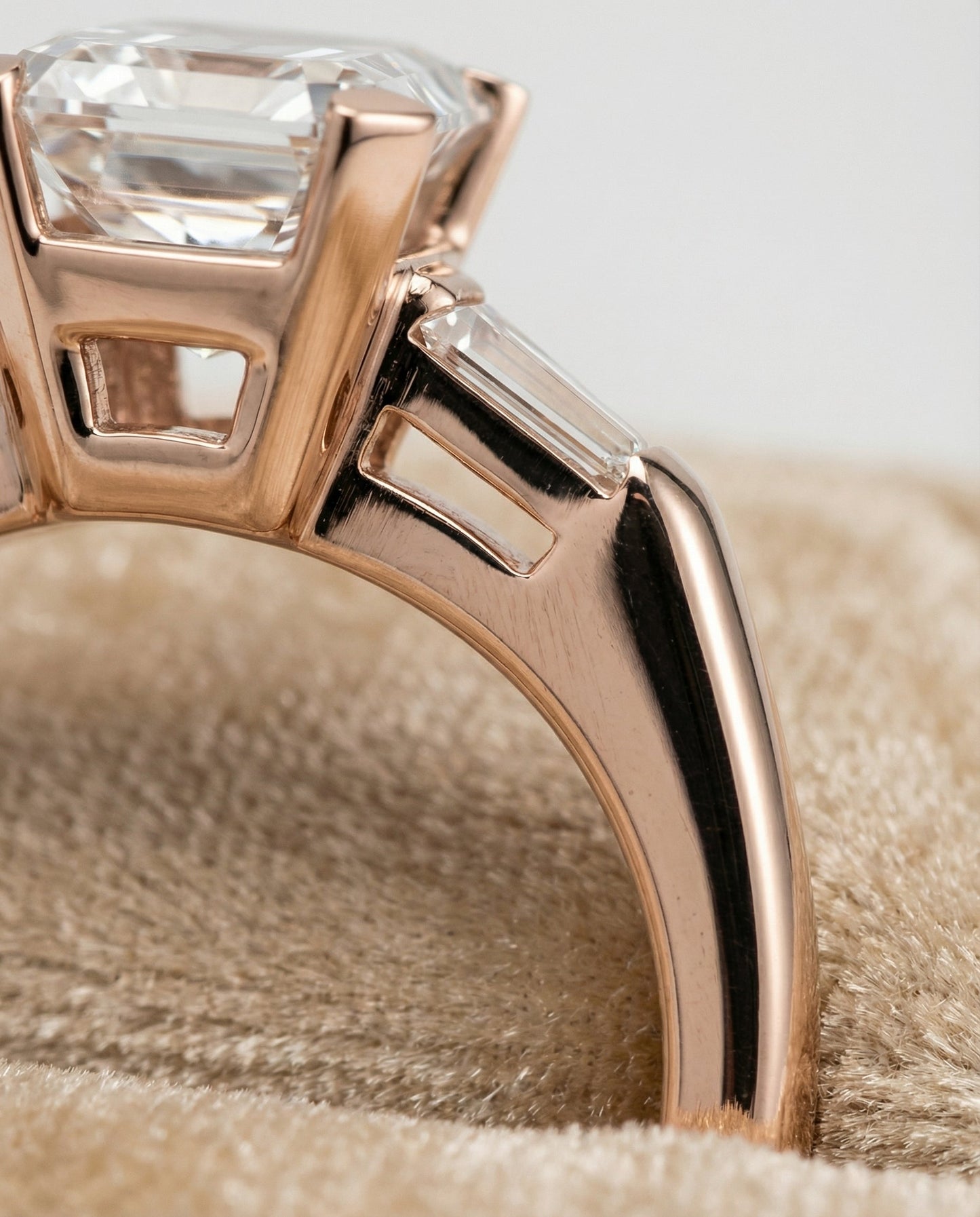 European Cut, Tapered Baguette Three Stone Emerald, in 14K Rose Gold, prong setting – detail view | RockHer