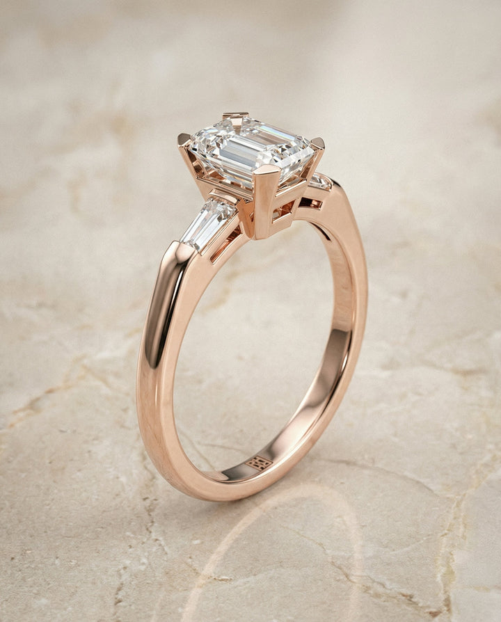 European Cut, Tapered Baguette Three Stone Emerald, in 14K Rose Gold, prong setting – front view | RockHer