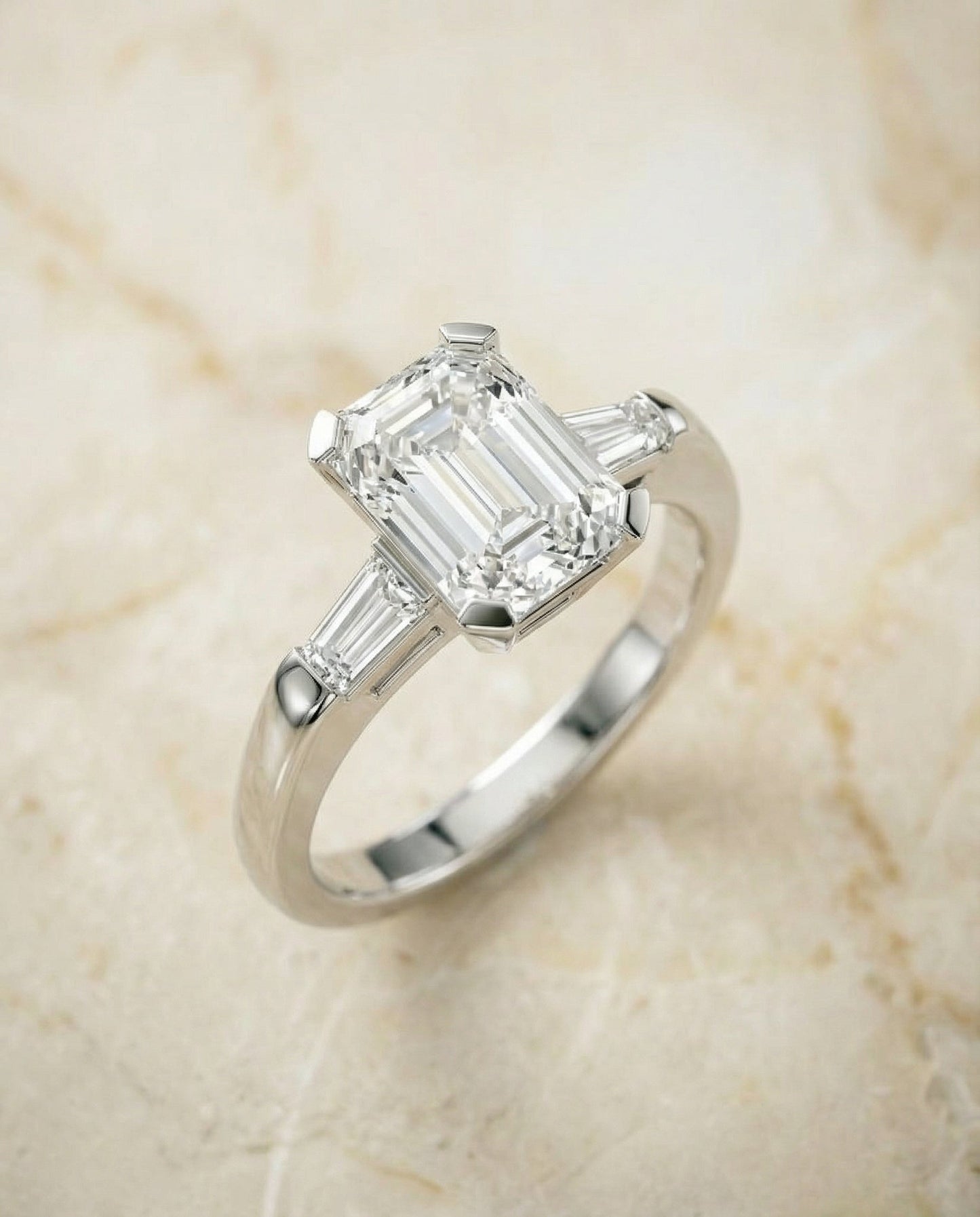 European Cut, Tapered Baguette Three Stone Emerald, in Platinum – angled view | RockHer