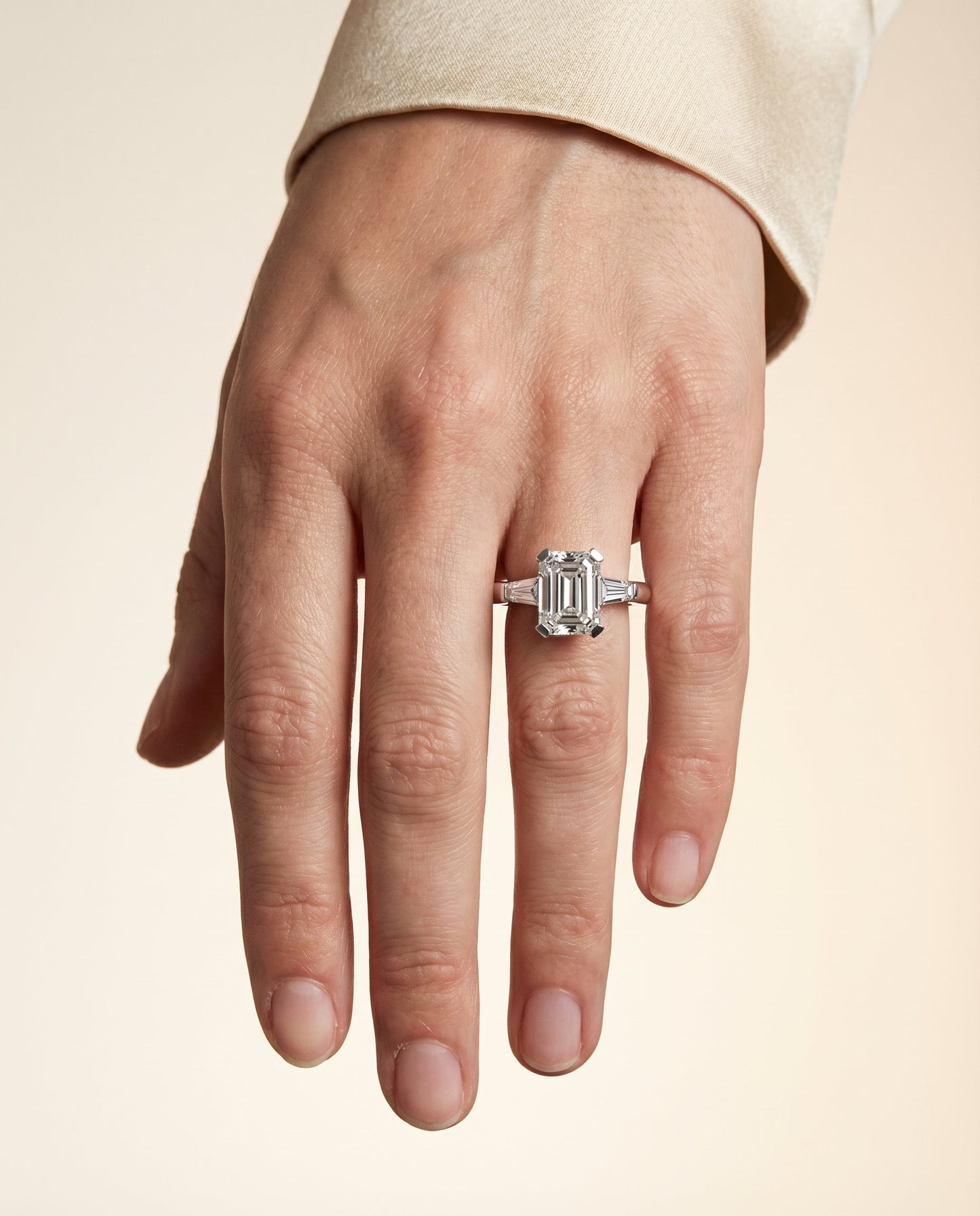 European Cut, Tapered Baguette Three Stone Emerald, in Platinum – lifestyle shot | RockHer