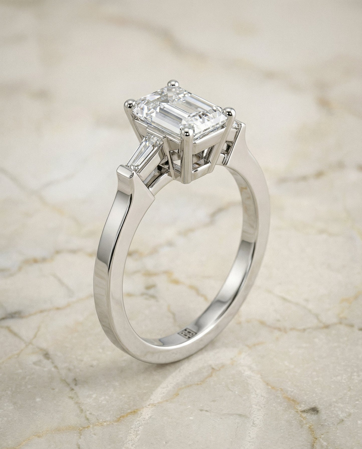 European Cut, Tapered Baguette Three Stone Emerald, in Platinum, channel setting – front view | RockHer