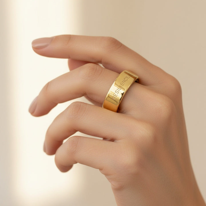 RESILIENCE engraved 14K Yellow Gold Oura Ring cover worn on hand