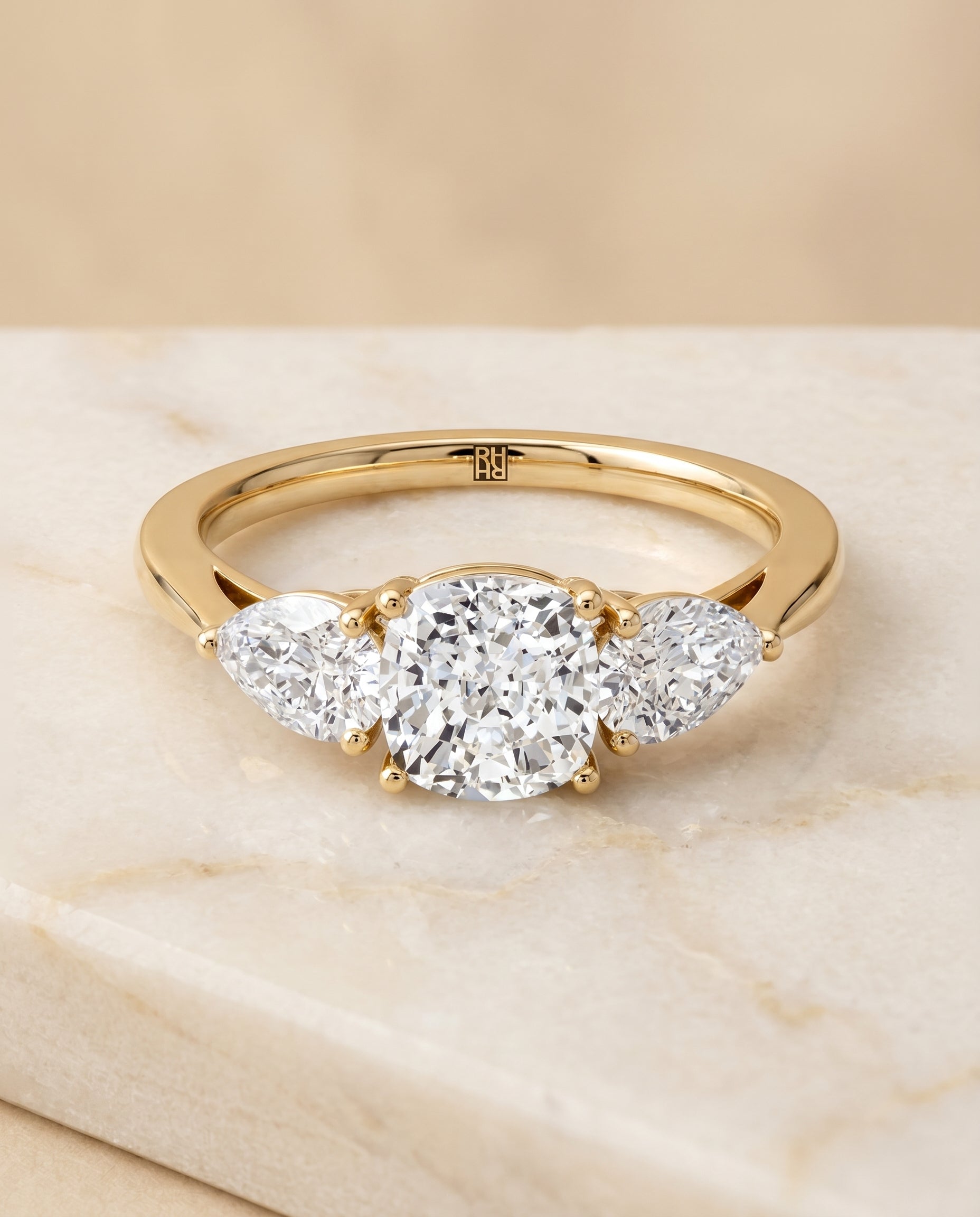แหวนหมั้นประดับเพชร Angelica Three Stone แบบ Cushion Cut ตัวเรือนทอง 18K