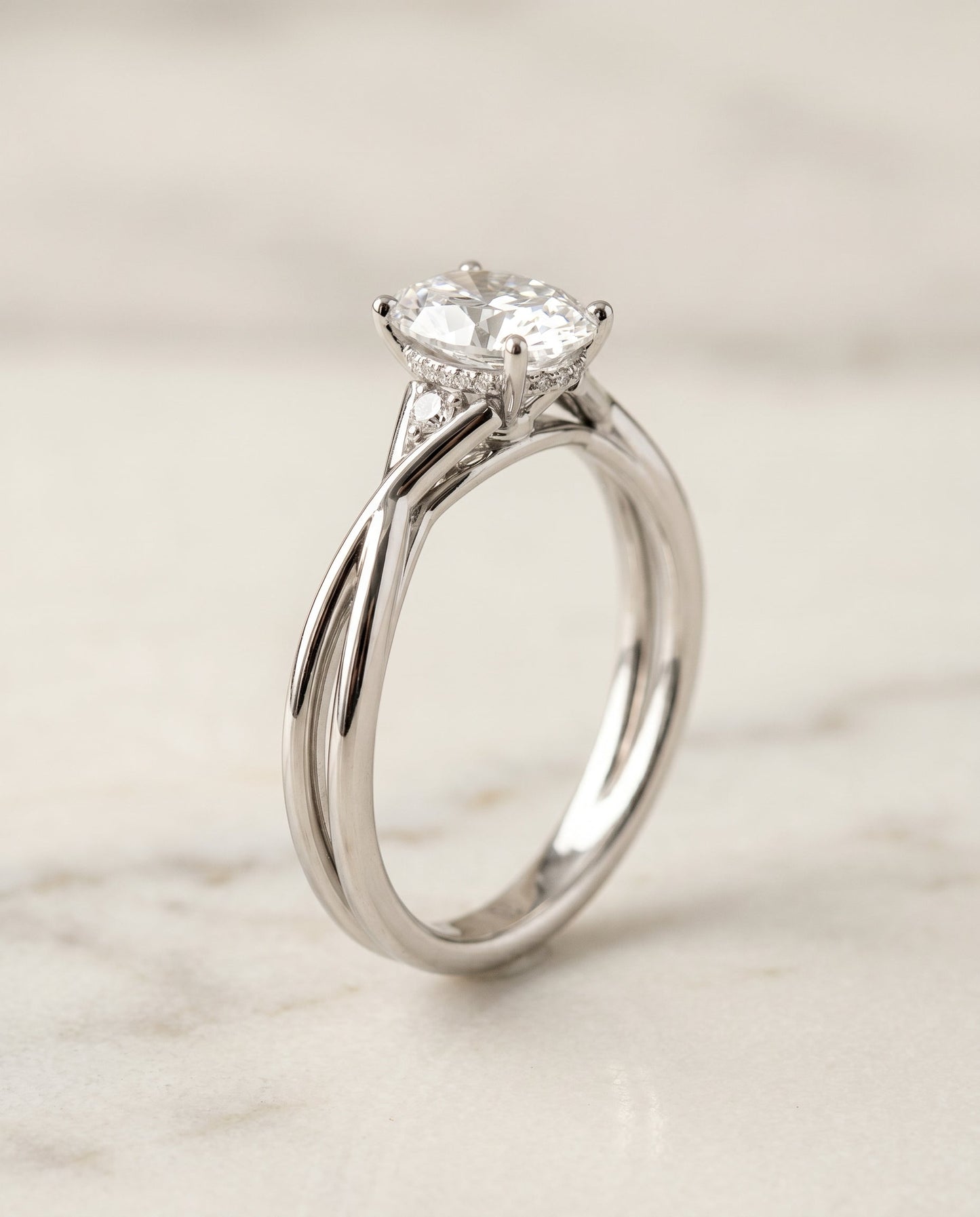 The Dusty Twisted Hidden Halo Solitaire Engagement Ring Setting for Oval Diamonds in 18K White Gold
