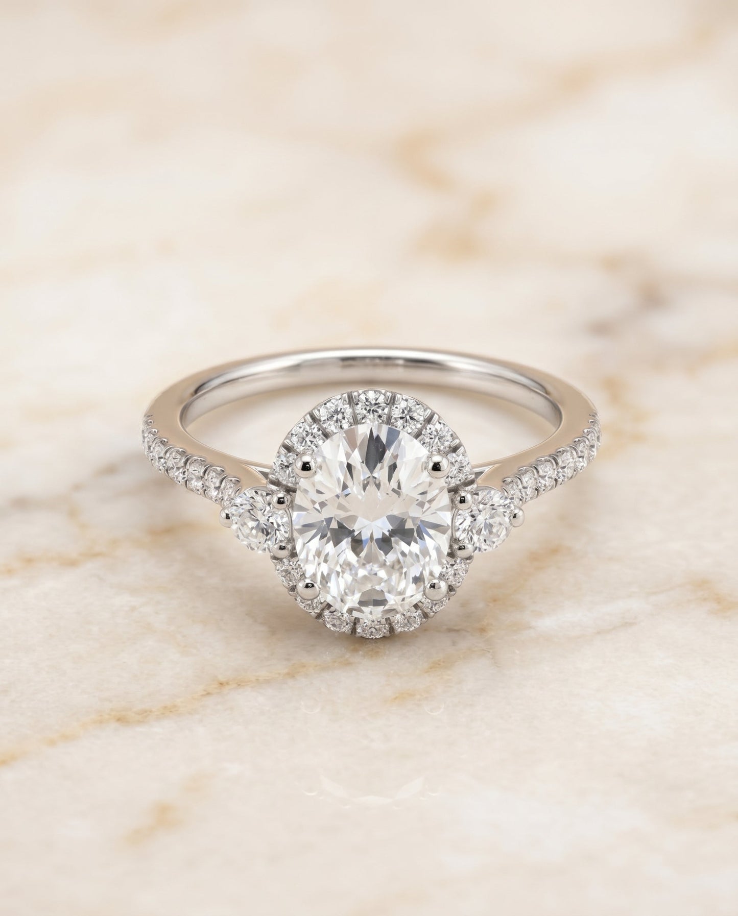 Ivy Select Three Stone Delicate Halo Oval in Platinum – view 1