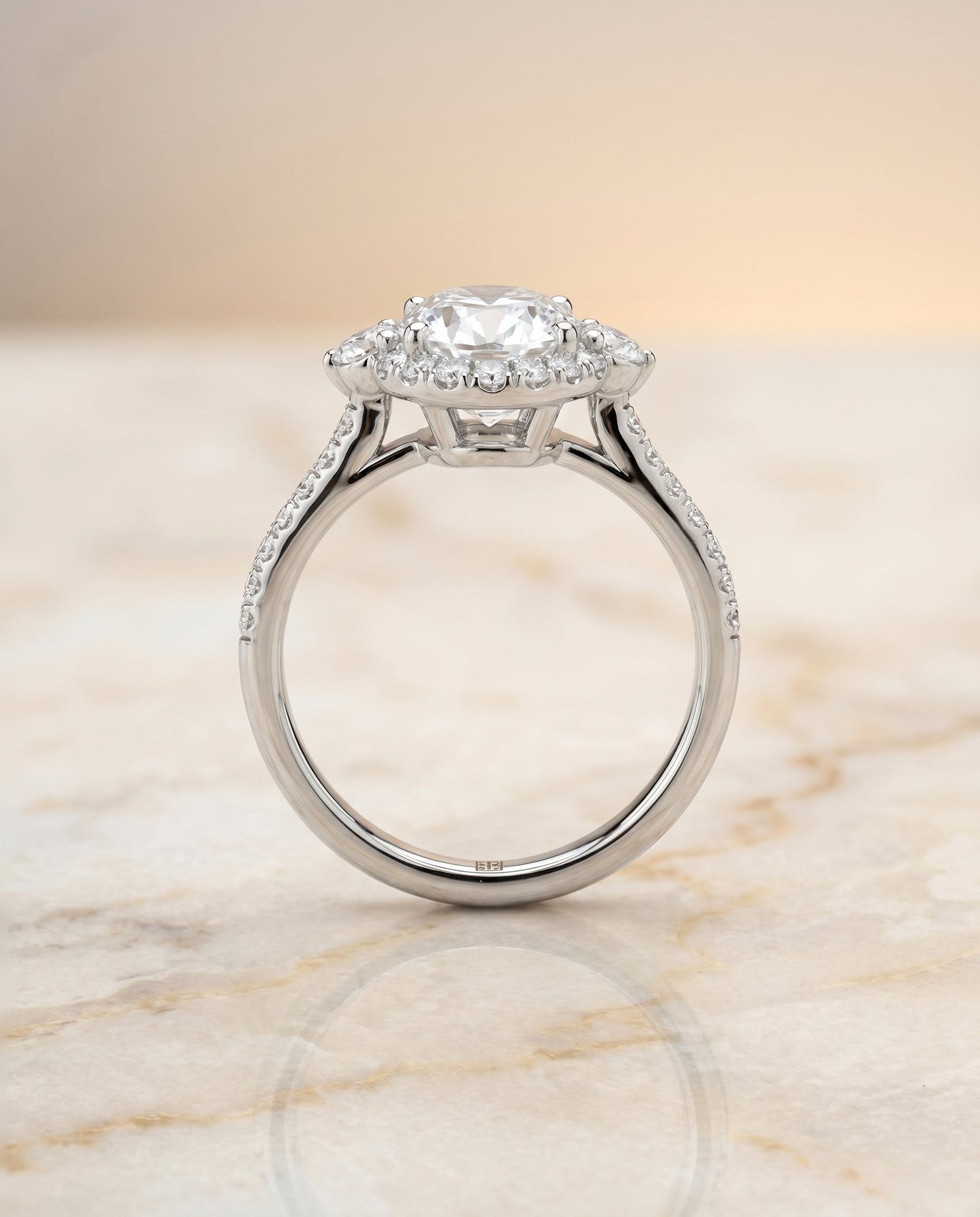Three Stone Delicate Halo Oval, in Platinum – side profile | RockHer
