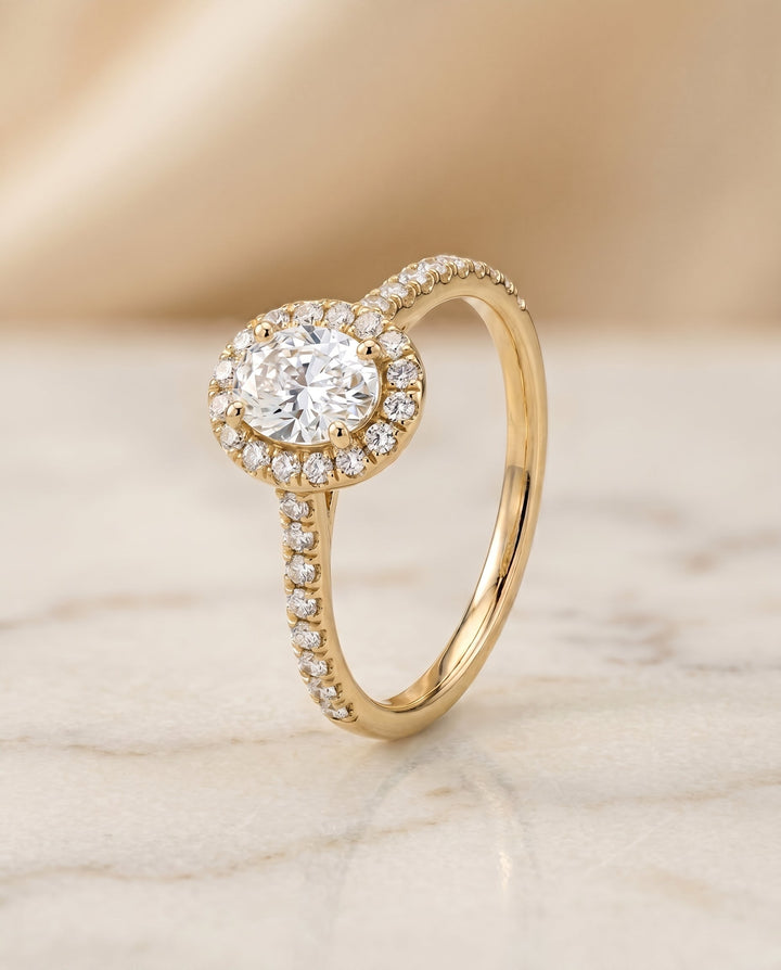 The Sade Pavé Halo Engagement Ring Setting for Oval Diamonds in 18K Yellow Gold