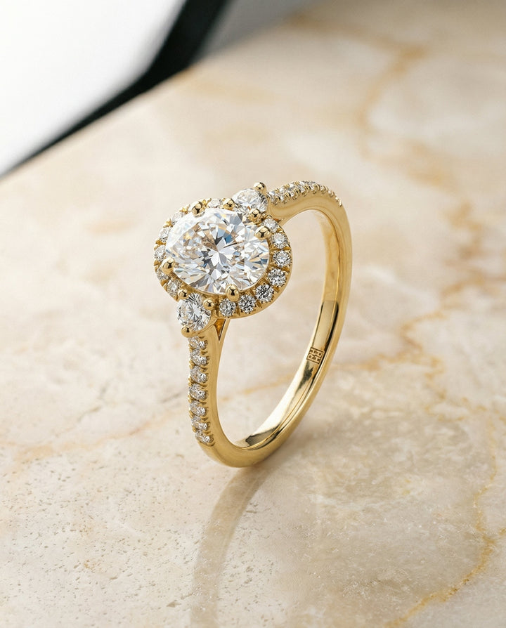 Three Stone Delicate Halo Oval, in 18K Yellow Gold – front view | RockHer