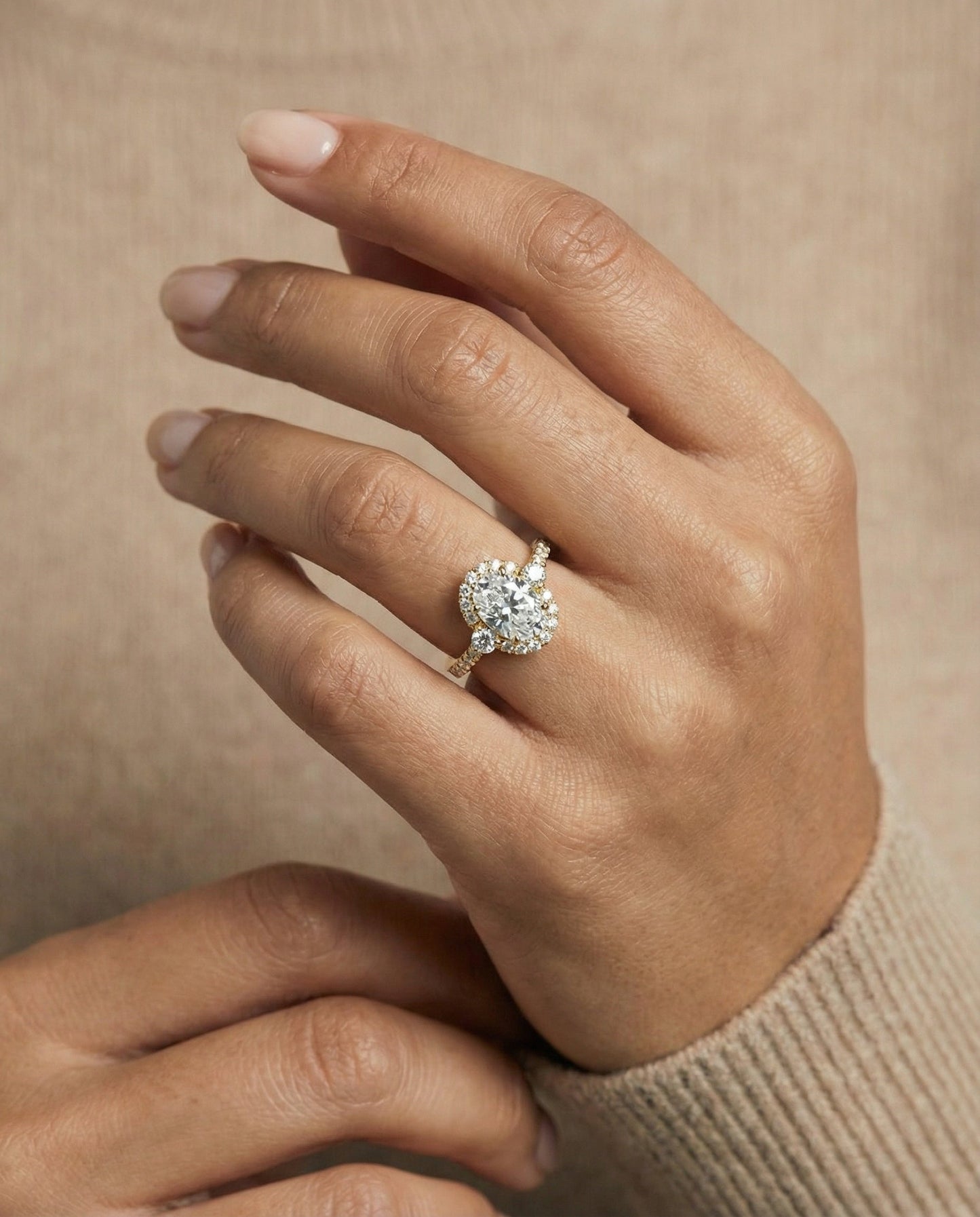 Ivy Select three stone delicate halo oval oval ring in 14K Yellow Gold — on hand angled — RockHer