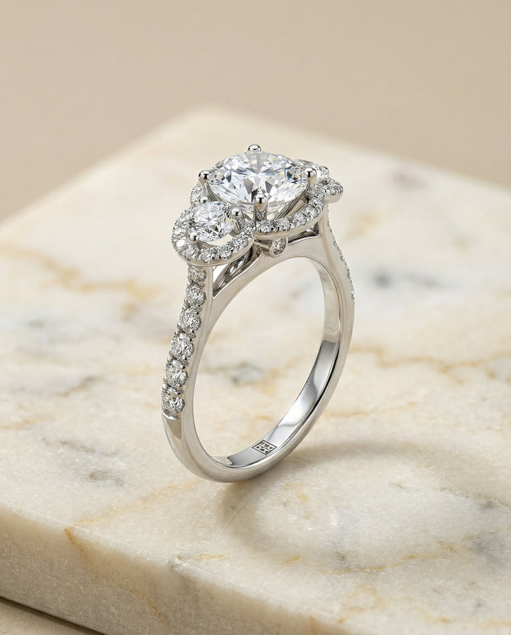 Round Brilliant, Three Stone Halo, in Platinum, pave setting – front view | RockHer