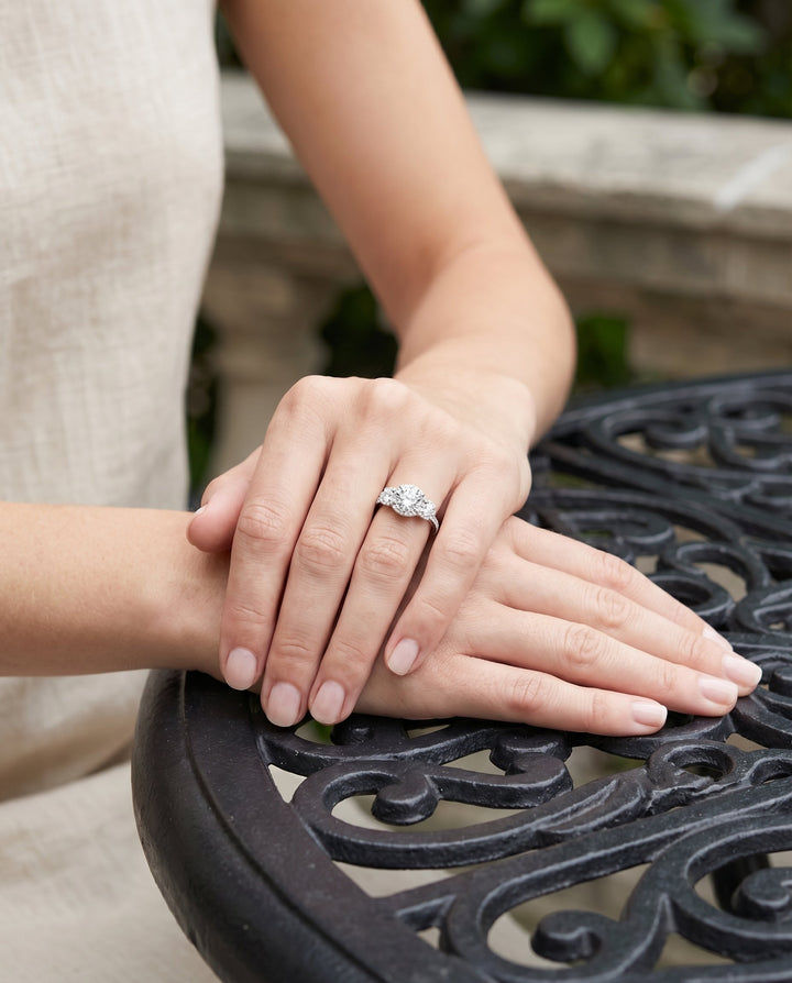 Round Brilliant, Three Stone Halo, in Platinum, pave setting – lifestyle shot | RockHer