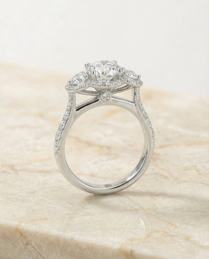 Round Brilliant, Three Stone Halo, in Platinum, pave setting – side profile | RockHer