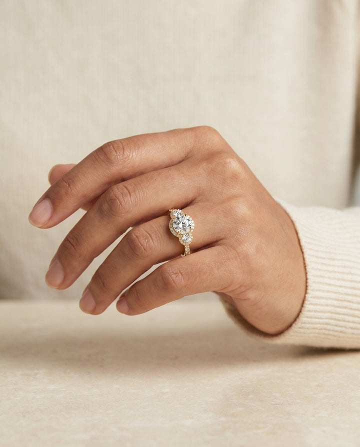 Round Brilliant, Three Stone Halo, in 18K Yellow Gold, pave setting – lifestyle shot | RockHer