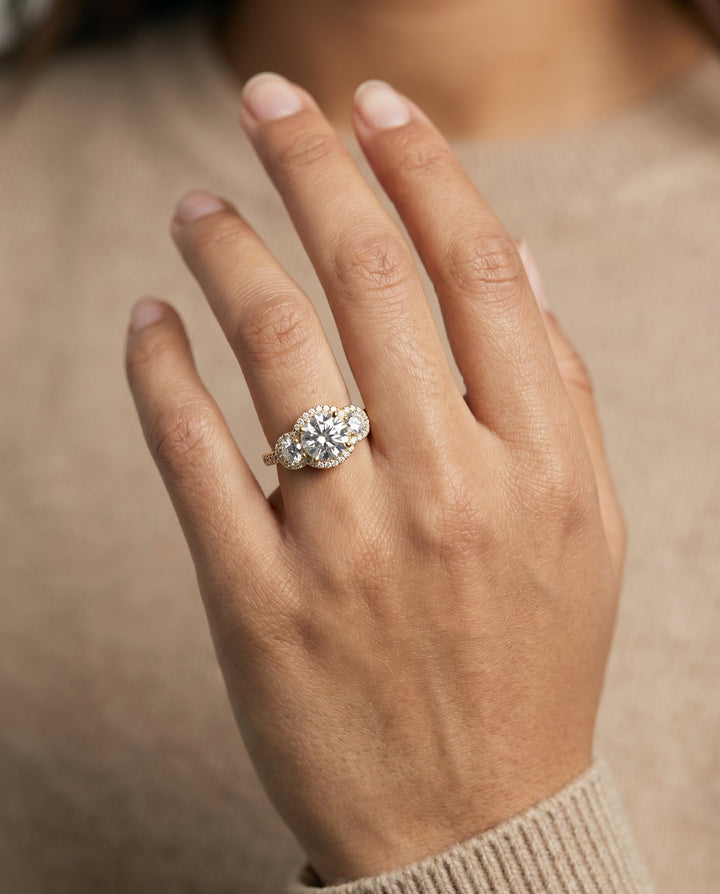 Round Brilliant, Three Stone Halo, in 18K Yellow Gold, pave setting – lifestyle shot | RockHer