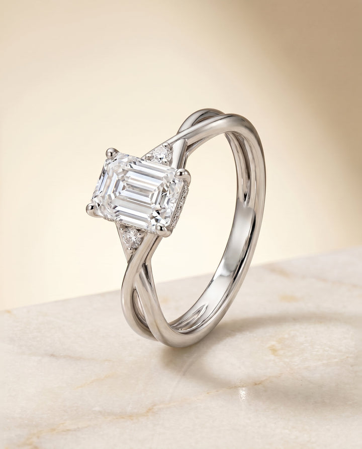 แหวนหมั้นดีไซน์ Dusty Twisted Hidden Halo Solitaire สำหรับเพชรทรงมรกต ตัวเรือนทองคำขาว 18K