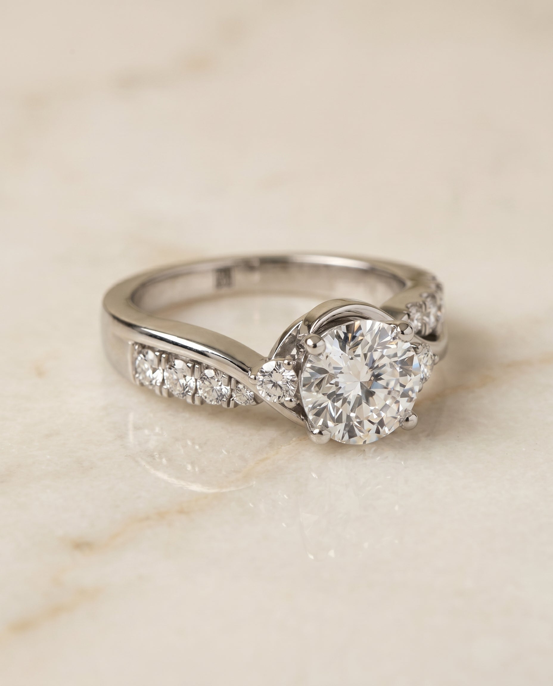 Round Brilliant, Twisted Three Stone, in 18K White Gold – angled view | RockHer