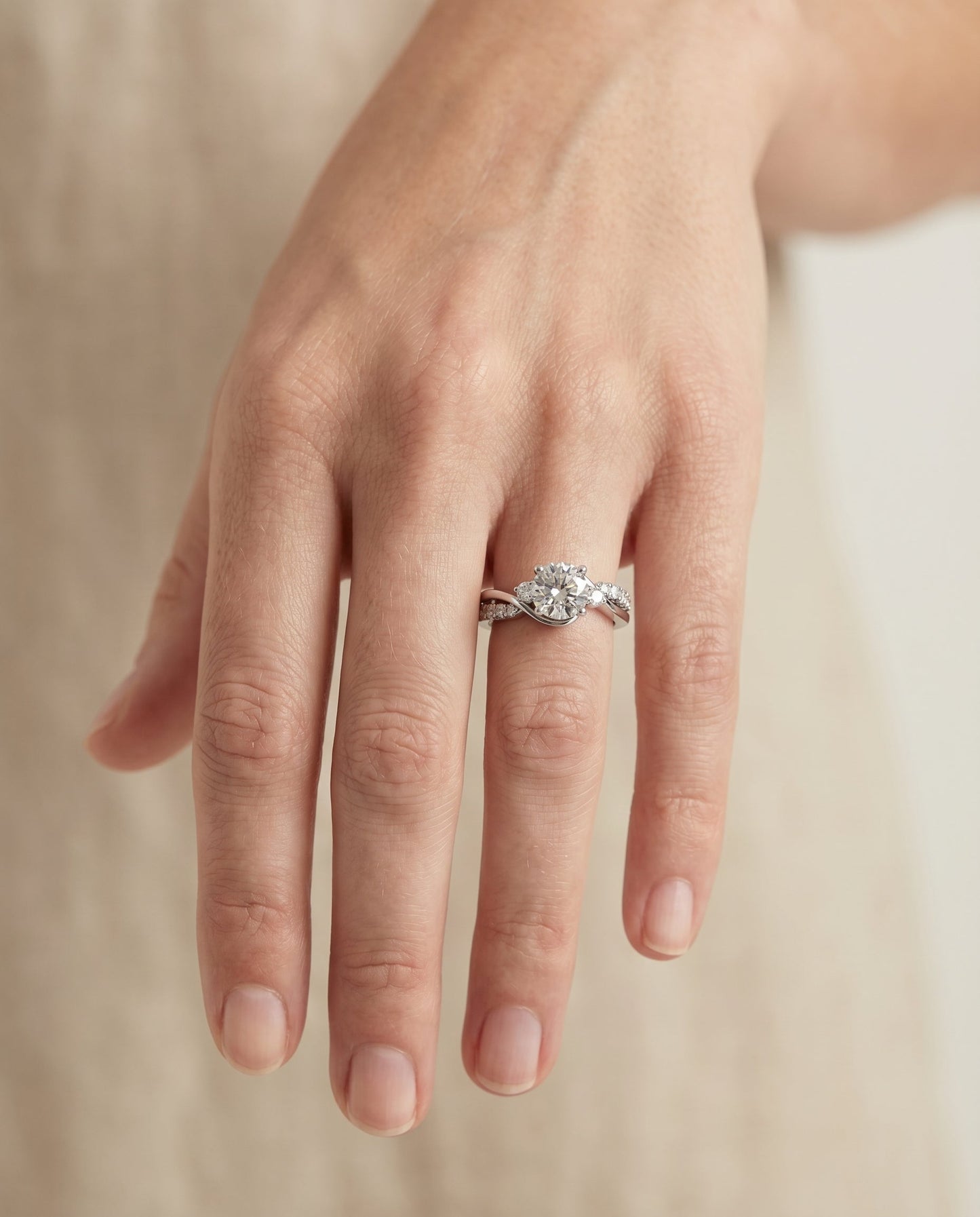 Round Brilliant, Twisted Three Stone, in 18K White Gold – lifestyle shot | RockHer