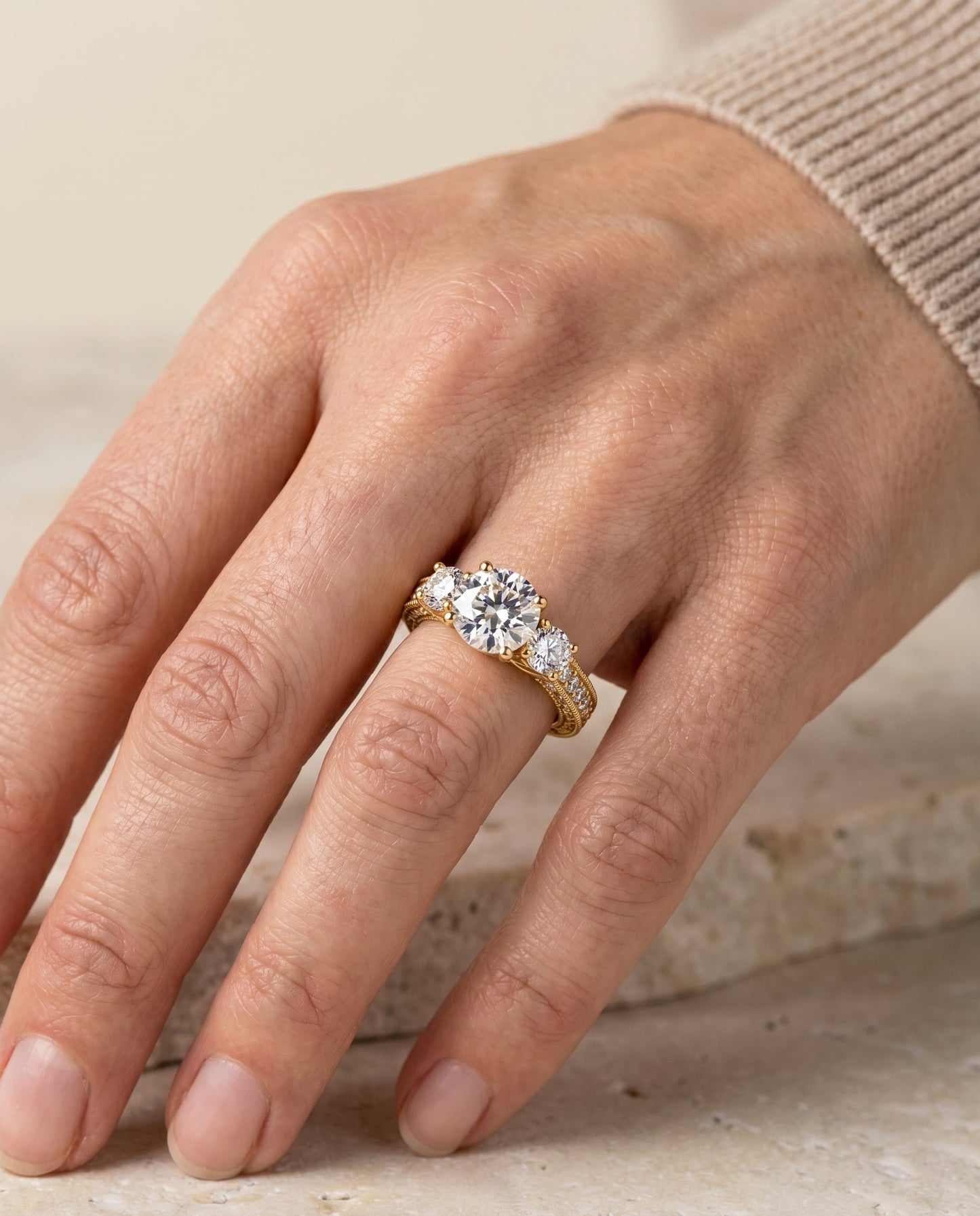 Round Brilliant, Vintage Scroll Three Stone, in 18K Yellow Gold, pave setting – lifestyle shot | RockHer